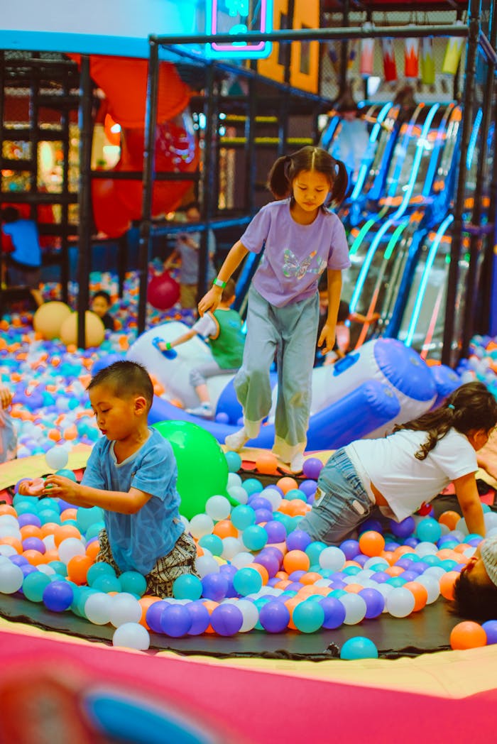services-03 Children having fun in a colorful indoor ball pit playground.