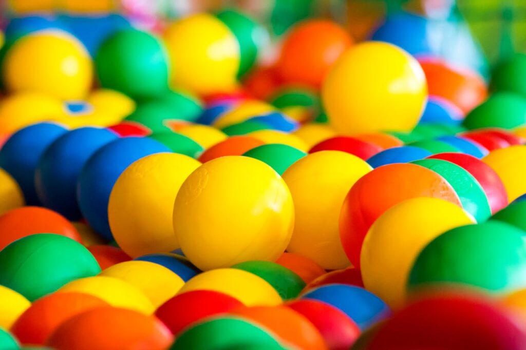 pexels photo 6827970 A close-up of a colorful ball pit filled with bright plastic balls for fun and play.