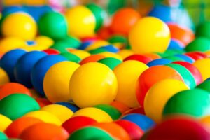 A close-up of a colorful ball pit filled with bright plastic balls for fun and play.
